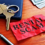 Rental scam sign with key and house keychain